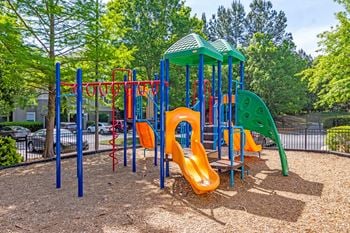 A playground at a park with slides and other playground equipment